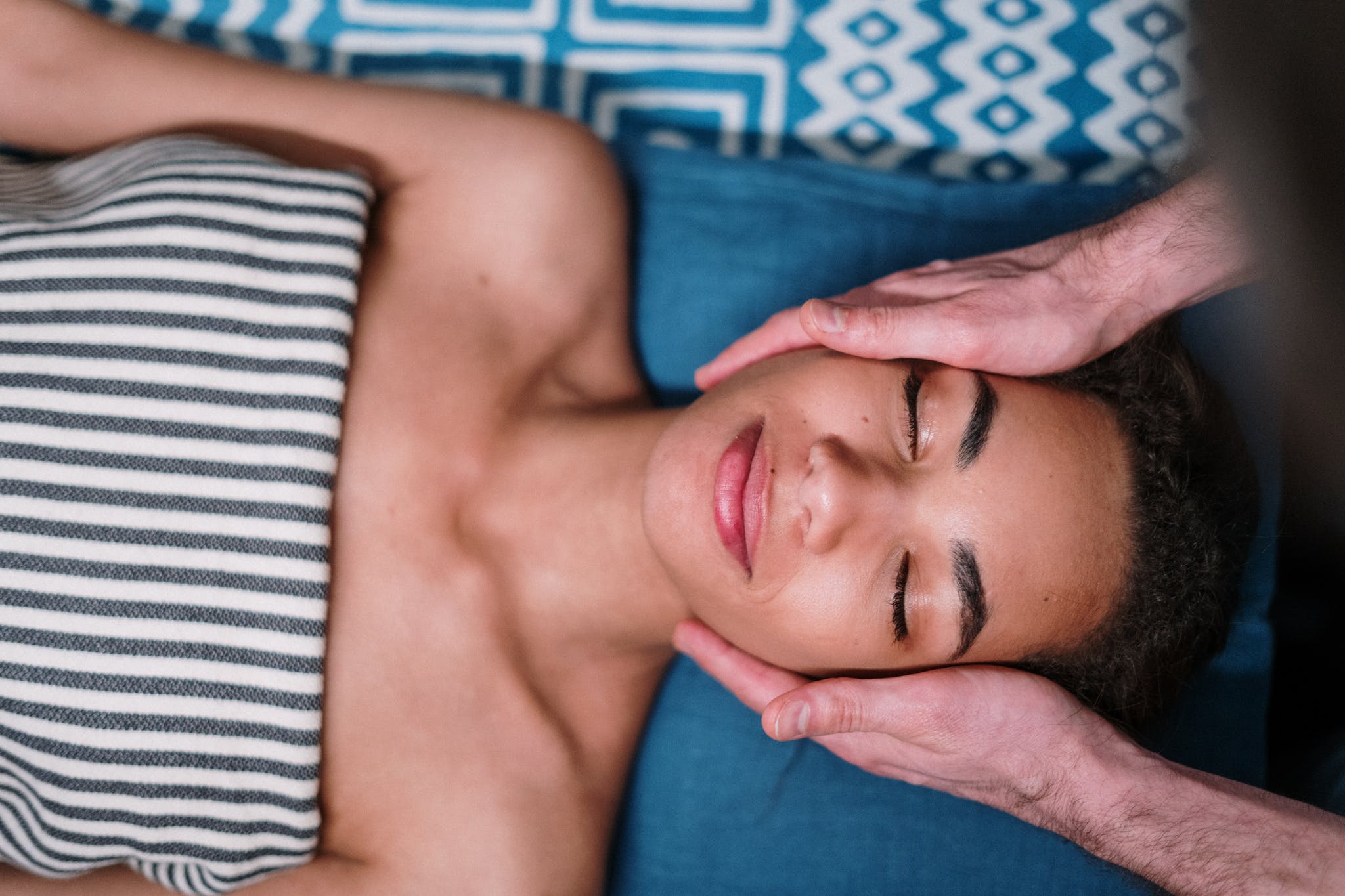 man lying on blue and white